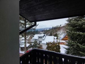 a balcony with a view of a snow covered mountain at Męcikówka in Szczyrk