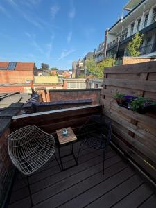 two chairs and a table on a wooden deck at Minimalist apartment - Lier center in Lier