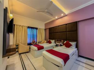 a hotel room with two beds and a tv at Zip By Spree Hotels Surabi International Vellore in Vellore +58 photos