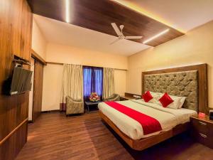 a hotel room with a bed and a television at Zip By Spree Hotels Surabi International Vellore in Vellore