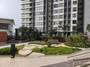 a large apartment building with a garden in front of it at Sunsuria Forum Soho by Diamond in Shah Alam
