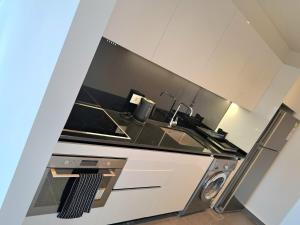 a kitchen with a stove and a sink at SAIFI Apartments in Beirut
