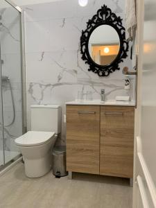 a bathroom with a toilet and a mirror at Discovery Apartment Carnaxide in Carnaxide +89 photos