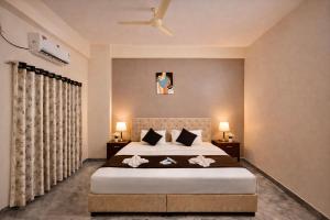 a bedroom with a large bed with two pillows at Hotel Sai 9 Heaven A Quality Apartment Perfect for Families in Shirdi +35 photos