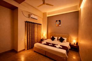 a bedroom with a bed with flowers on it at Hotel Sai 9 Heaven A Quality Apartment Perfect for Families in Shirdi