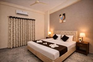 a bedroom with a large bed with flowers on it at Hotel Sai 9 Heaven A Quality Apartment Perfect for Families in Shirdi