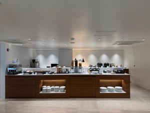 a kitchen with a counter with white bowls on it at Hotel Prince Seoul in Seoul
