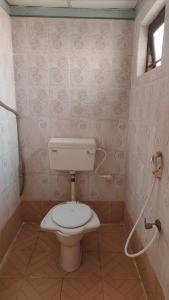 a bathroom with a toilet and a shower at Hotel Mainak Mandarmoni in Mandarmoni +14 photos