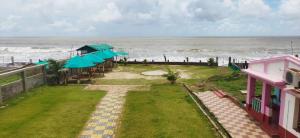 a view of the ocean from the balcony of a house at Hotel Mainak Mandarmoni in Mandarmoni