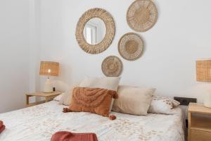 a bedroom with a bed with pillows and a mirror at Fuengirola I in Fuengirola