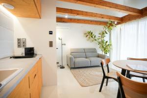 a kitchen and living room with a couch and a table at GG3 guesthouse in Eger