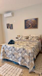 a bedroom with a bed with a blanket on it at Studio de Hóspedes - 150m da Praia in Rio de Janeiro