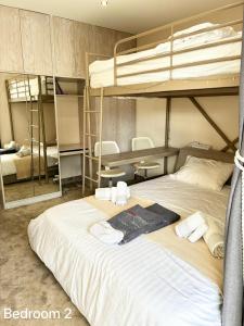a bedroom with a large bed with two bunk beds at Villasonboard 3 Bed Penthouse Veranda Beach view jacuzzi Vouliagmeni Riviera in Athens +24 photos