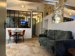 a living room with a couch and a table at La Merletière in Cholet
