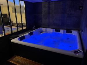 a large blue bath tub in a room at La Merletière in Cholet