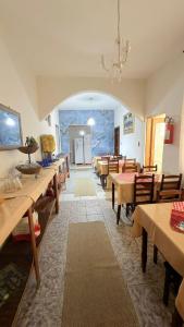 a room with wooden tables and chairs and a classroom at Pousada A CASA DE IRENE in Aparecida