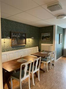 ein Esszimmer mit einem Holztisch und Stühlen in der Unterkunft Vita huset at Stora Le in Ed