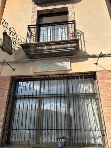 a building with barred windows on the side of it at Hotel Cadalso - Casa Moncho in Cadalso de los Vidrios