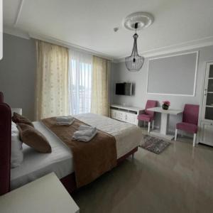 a bedroom with a bed and a table and chairs at Adonis 204 in Zlatibor