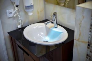 a bathroom sink with a faucet on a counter at Adonis 204 in Zlatibor