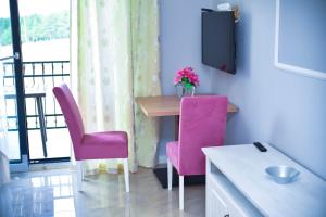 a room with a table and two pink chairs at Adonis 204 in Zlatibor +17 photos