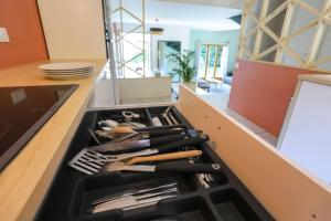a kitchen counter with a drawer full of utensils at Les Eaux Vives in Sévrier
