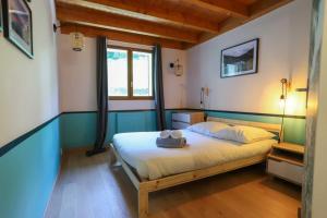 a bedroom with a bed with a hat on it at Les Eaux Vives in Sévrier