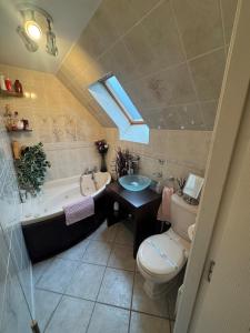 a bathroom with a toilet and a tub and a sink at Sea View House in Dalkeith +34 photos