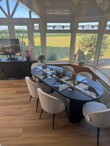 a dining room with a blue table and chairs at Sea View House in Dalkeith