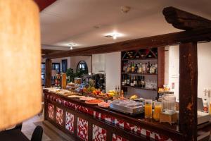a bar with a buffet of food and drinks at Hostal Nau Pradets in Vielha