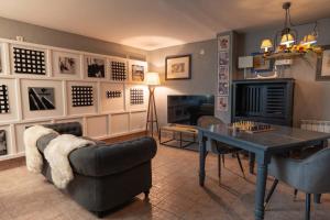 a living room with a table and a couch at Hostal Nau Pradets in Vielha