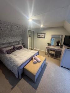 a bedroom with a large bed with a stone wall at Sea View House in Dalkeith