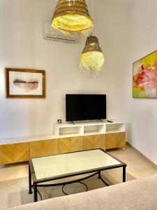 a living room with a tv and a coffee table at Loft Manuel Arellano in Seville