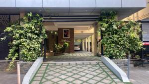 a hallway of a house with trees in it at Evania Pool Suites in Nedumbassery