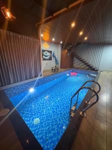 a large swimming pool in a building at Evania Pool Suites in Nedumbassery