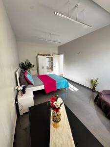 a bedroom with a bed and a table in it at Cozy Home with Terrace Views! in Ponta do Sol