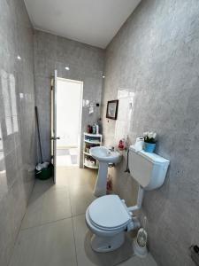 a bathroom with a toilet and a sink at Cozy Home with Terrace Views! in Ponta do Sol