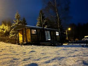 a small cabin in the snow at night at VAGONBublava in Bublava