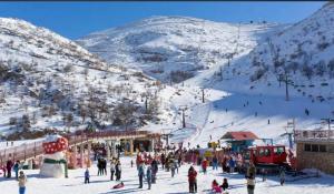 a group of people at a ski resort in the snow at The stone house by the river וילה ליד הנחל in Dafna