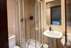 a bathroom with a shower and a sink and a toilet at Hostal Nau Pradets in Vielha +19 photos