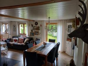 a living room with a table and a couch at Chalet Chic mit Hot Pot in Wildhaus