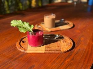 a drink in a glass sitting on a wooden table at Luma in Palolem
