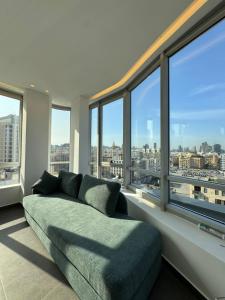 a living room with a couch and large windows at SAIFI Apartments in Beirut