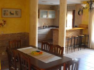 a kitchen with a table and chairs and a kitchen with a counter at CASA RURAL ALTA YUBERIA in Berlanga de Duero