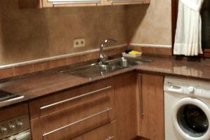 a kitchen with a sink and a washing machine at CASA RURAL ALTA YUBERIA in Berlanga de Duero +33 photos