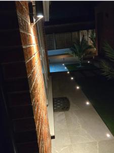 a brick wall with lights on the side of a house at The Cosy Pod Studio - Short Stay in Salford in Manchester