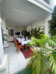 a dining room with tables and chairs on a patio at Trevors Home Place in Lagos