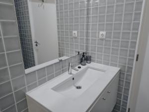 a bathroom with a white sink and a mirror at Casa da Delonga in Nordeste +22 photos