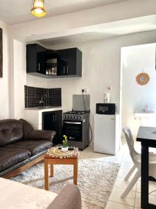 a living room with a couch and a stove at Rustic studio milimani in Kisumu