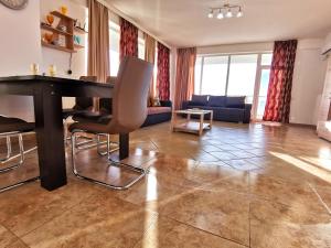 a living room with a piano and a couch at Elisa Summerland Apartment in Mamaia